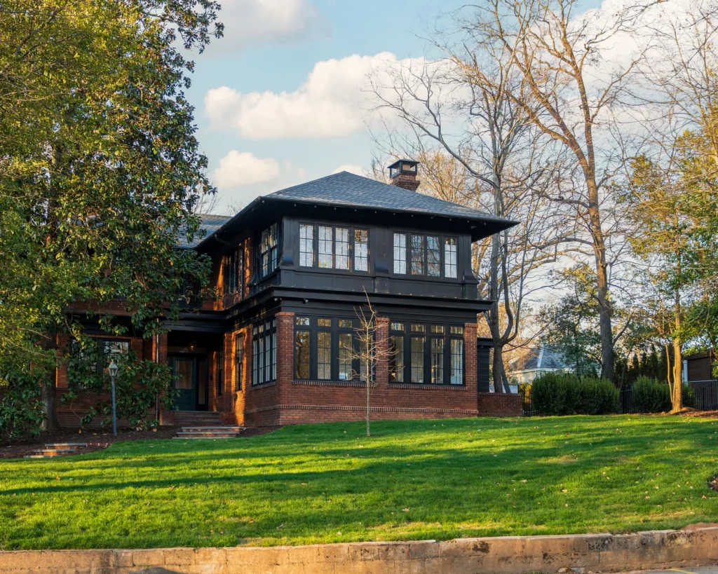 two story home with lush grass