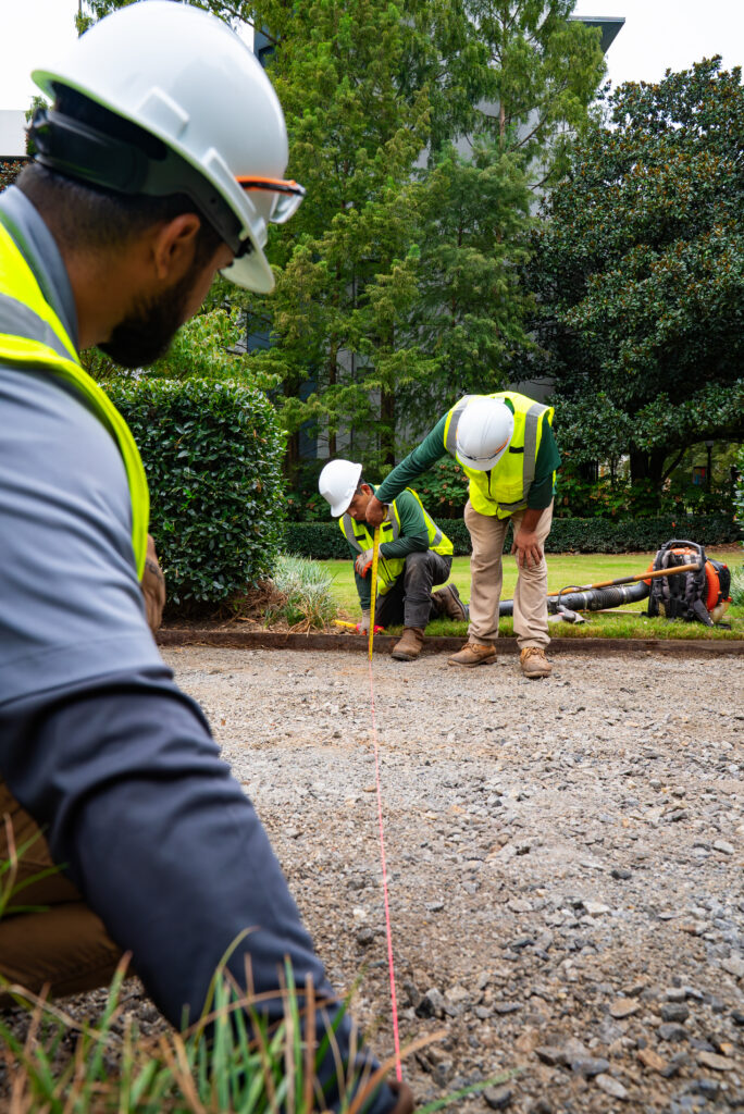 men measuring hardscaping area